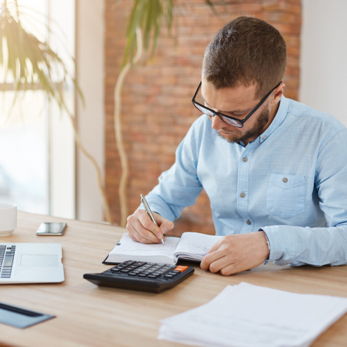 young-caucasian-male-manager-glasses-sitting-company-office